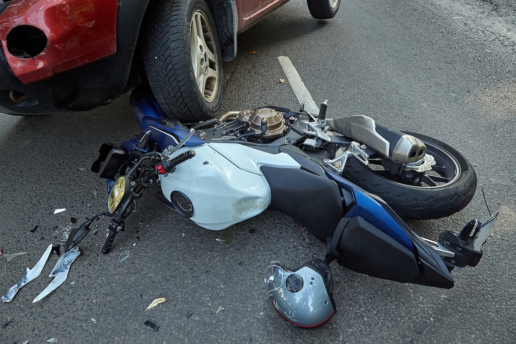 Damaged motorcycle and a car in a accident