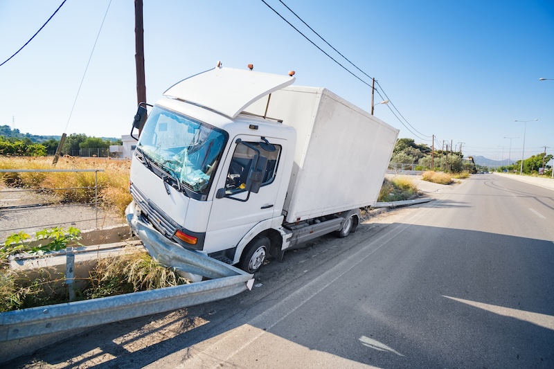 Henderson truck accident that hit crashed barrier on road, broken windshield, sunny day