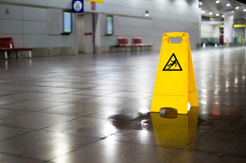 Slip and Fall accident possibility with water on floor with wet floor sign
